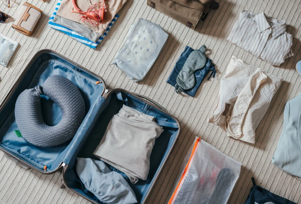 Top-View-Of-An-Open-Suitcase-With-Clothes-On-The-Floor-2151612473_2106x1427